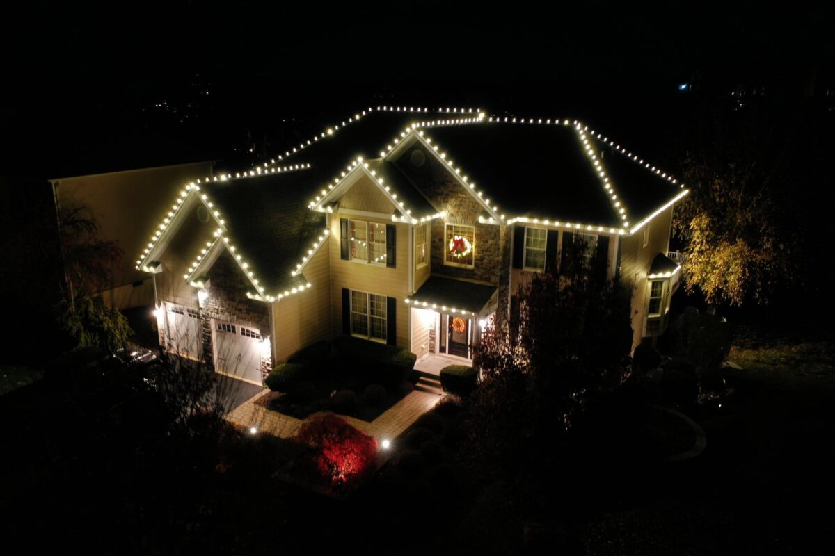 Permanent roofline lighting outlining the roofline of a home at night