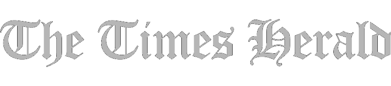 The Times Herald newspaper name in gray, old English style font on a white background.